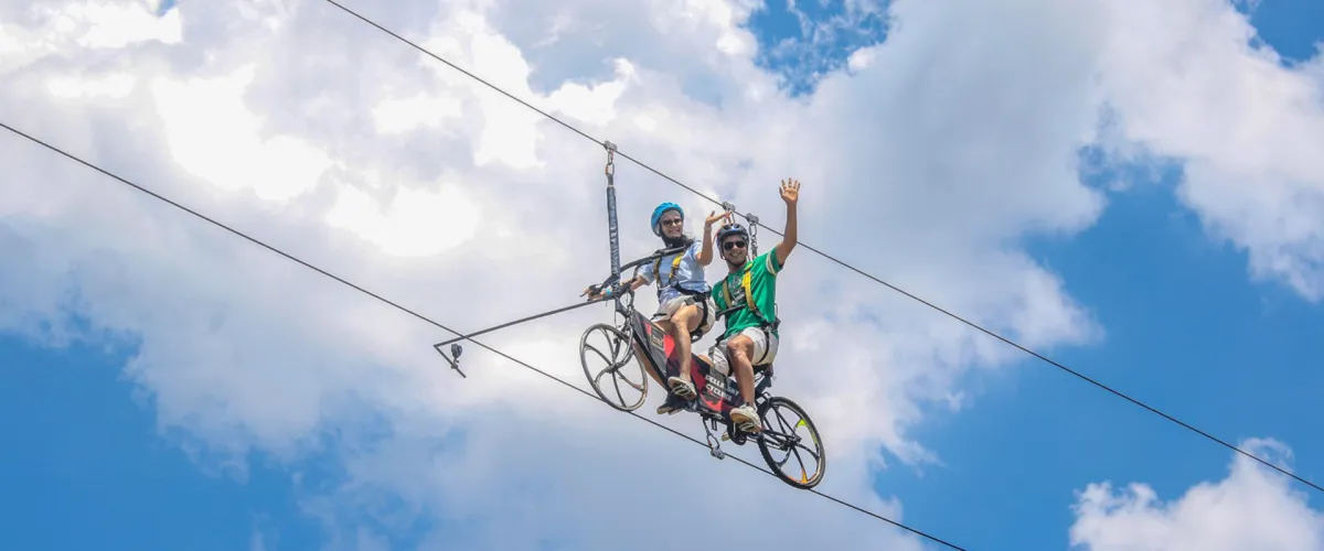 Two riders on the Sky Cycling rope track, 30 feet high