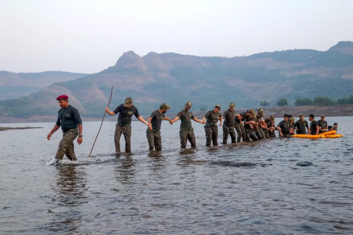 Trainees wading across Shirota Lake during survival training