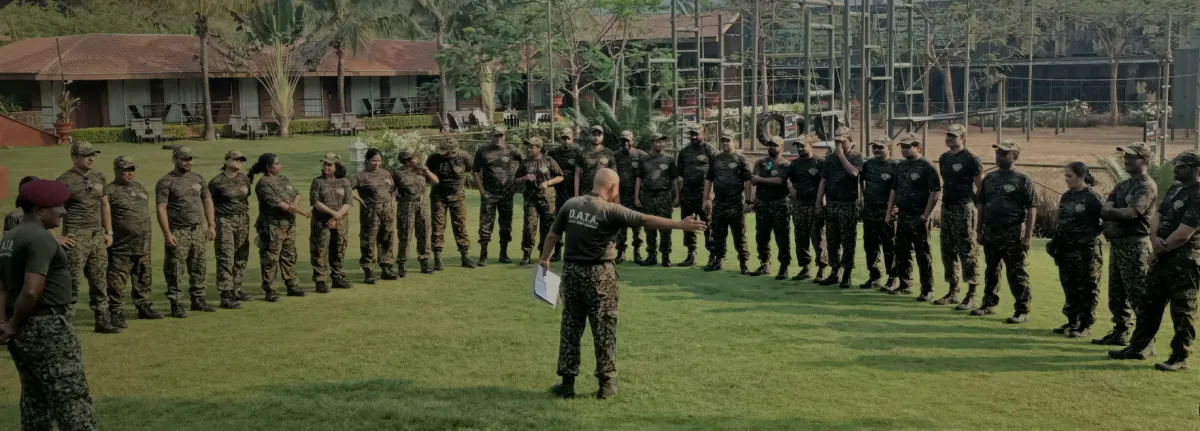 Trainees in camouflage in formation with an instructor at D.A.T.A.