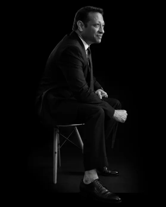 Jimmy Mistry, Founder & CMD of Della Group, seated on a stool, black-and-white portrait