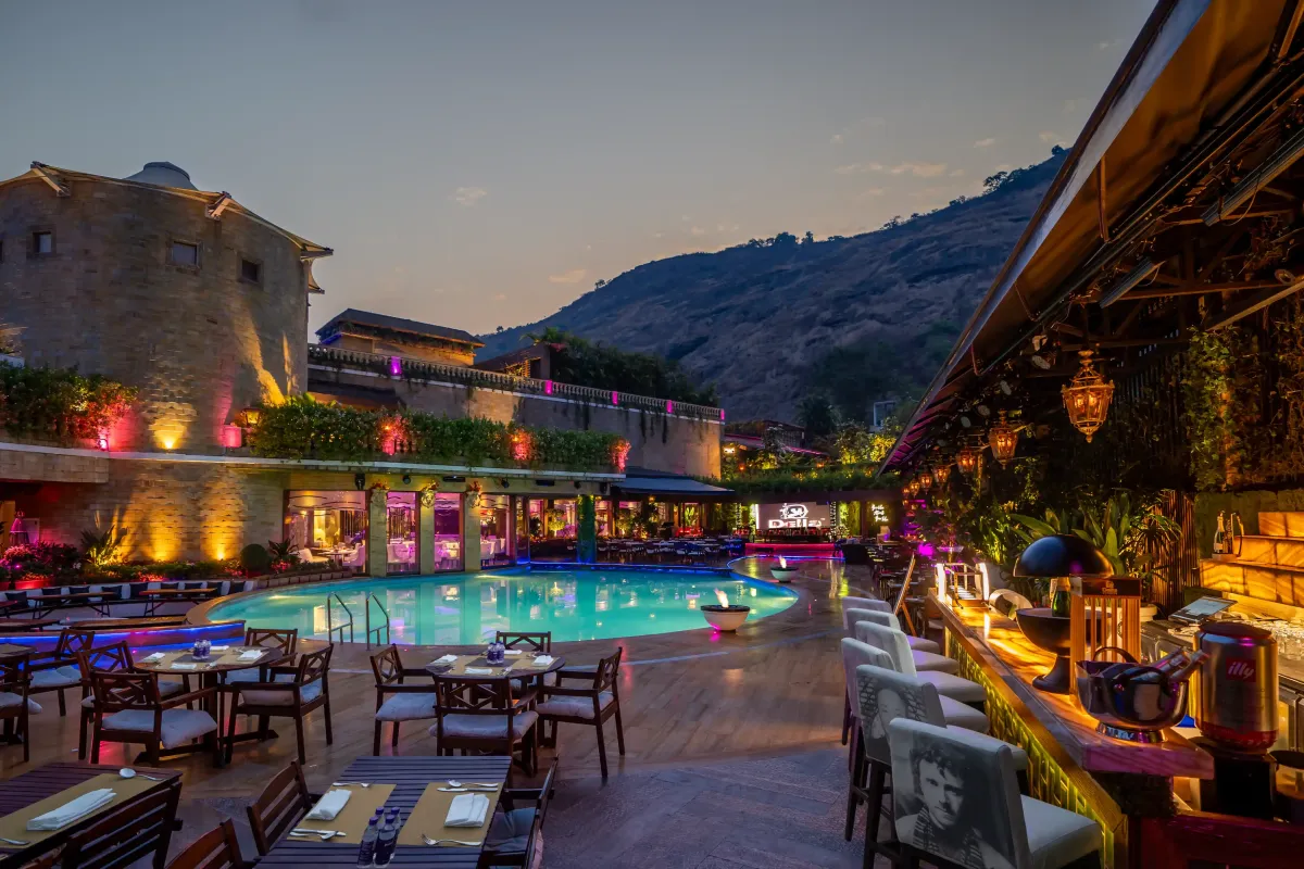Poolside dining at Café 24, Della Resorts' 24-hour fine-dining restaurant